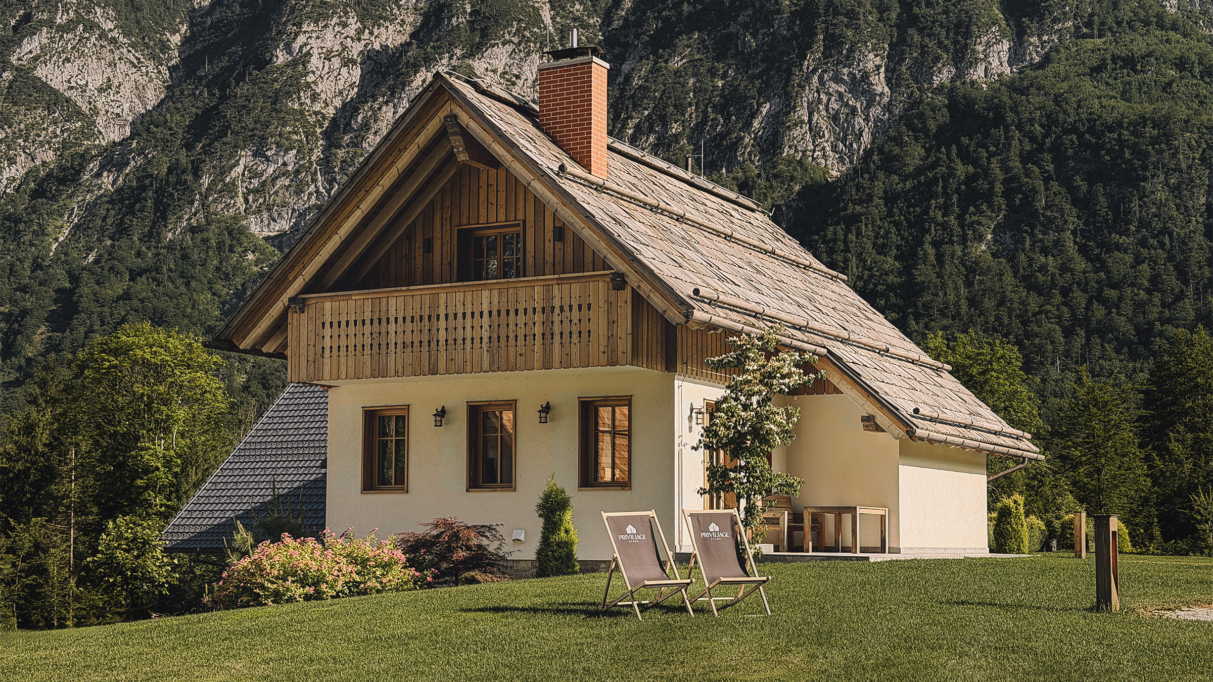Exterior of the Alpine SPA Chalet in Ukanc with a mountain backdrop near Lake Bohinj.