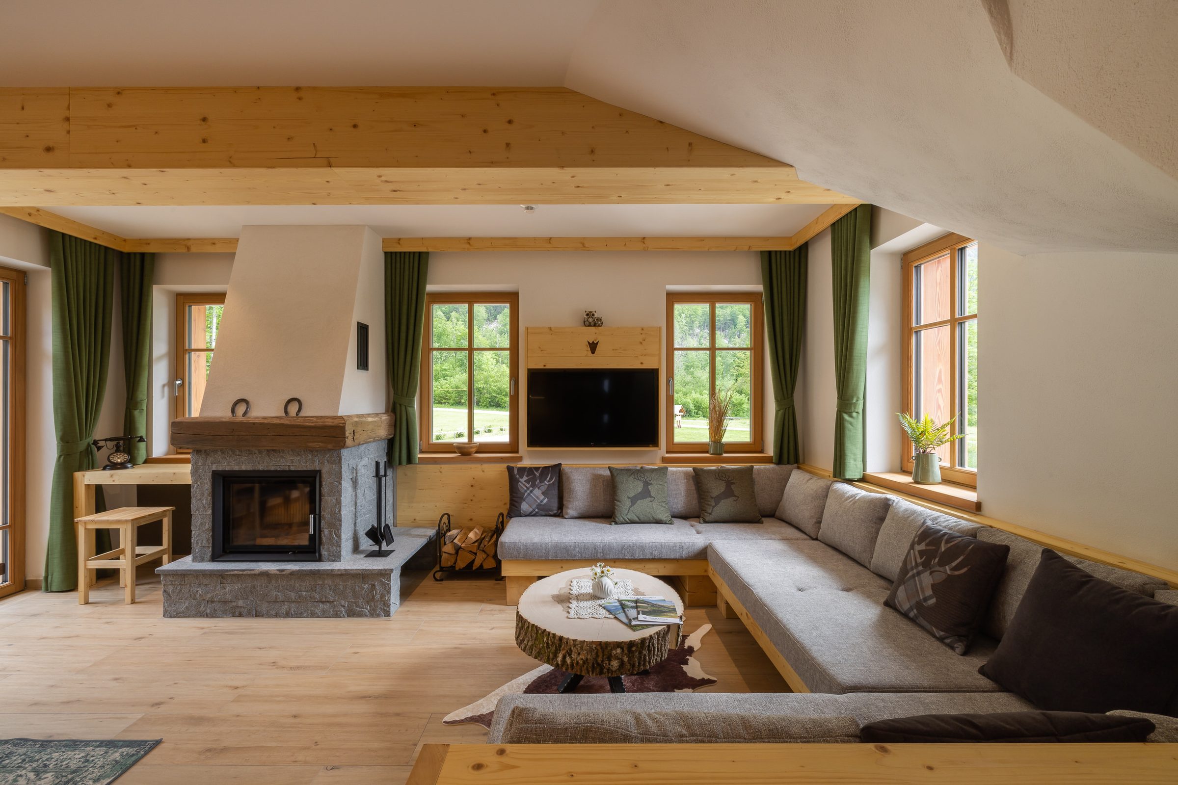 Living room with fireplace in the Alpine SPA Chalet at Privillage Stare near Lake Bohinj.
