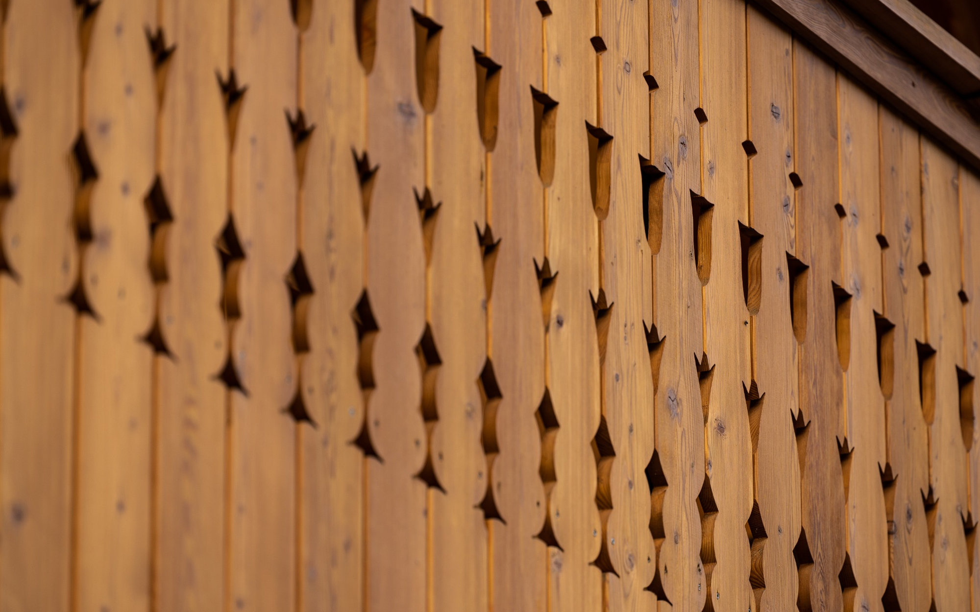 Traditional carved wooden balcony detail on the Alpine SPA Chalet in Bohinj.