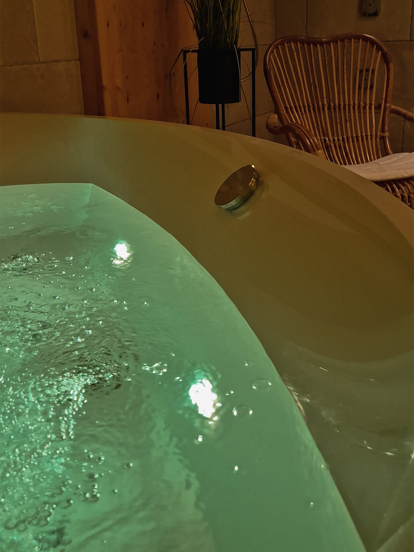 Whirlpool bath with hydromassage jets and colour therapy in the private wellness area of an Alpine SPA Chalet by Lake Bohinj.