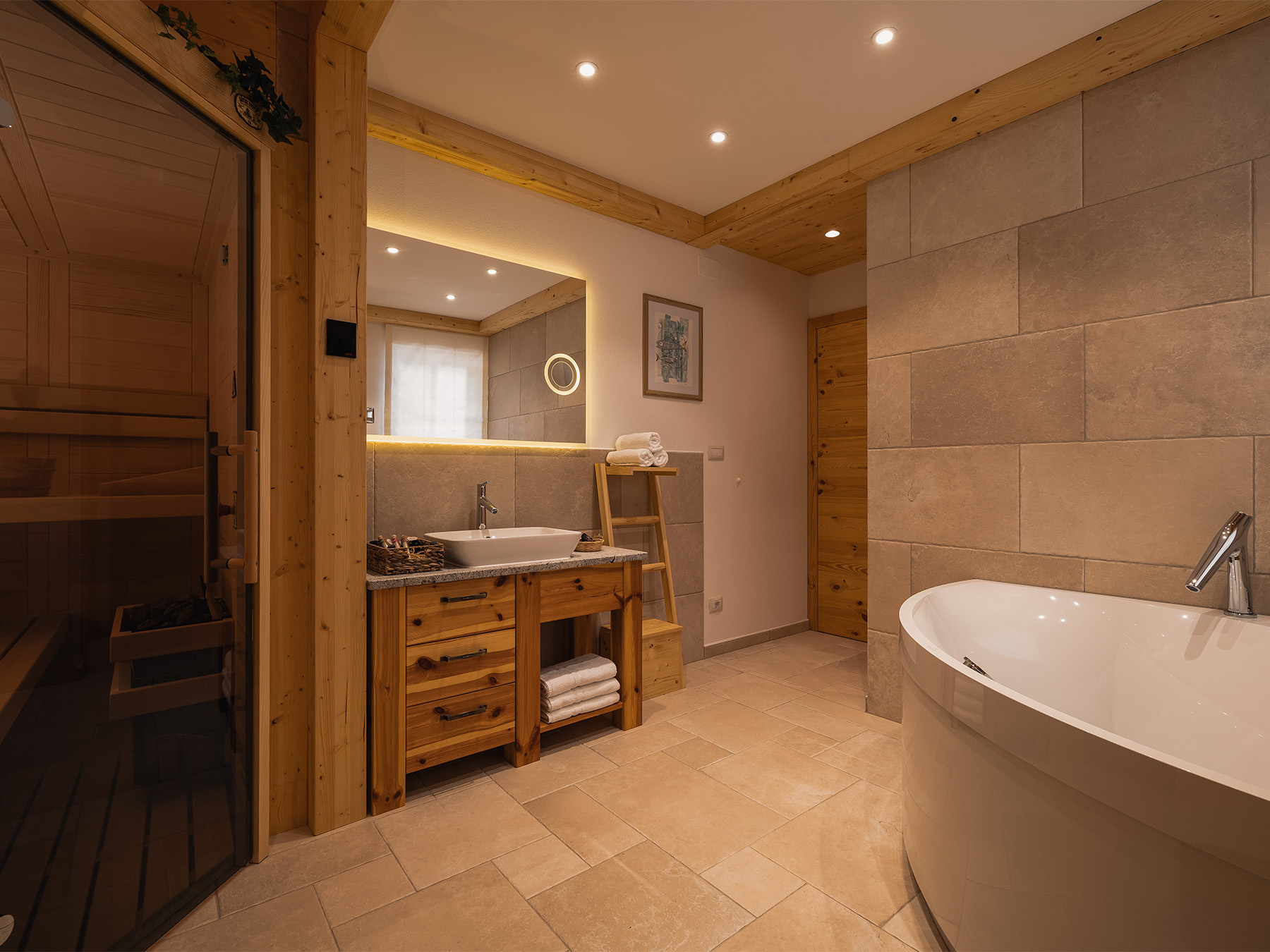 Private wellness interior with Finnish sauna and whirlpool bath in an Alpine SPA Chalet by Lake Bohinj.