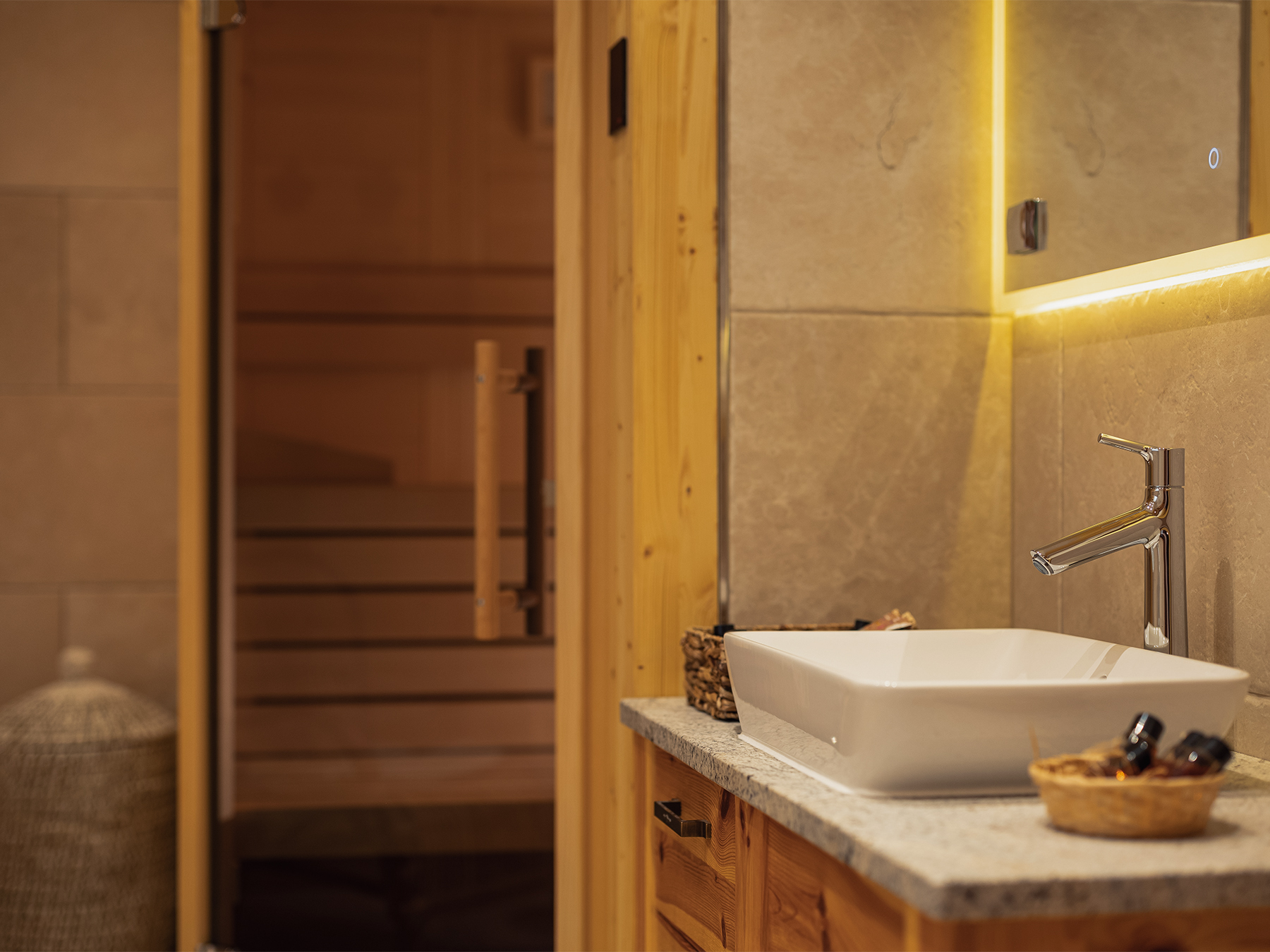Sink and warm sauna detail inside the private wellness area of an Alpine SPA Chalet by Lake Bohinj.